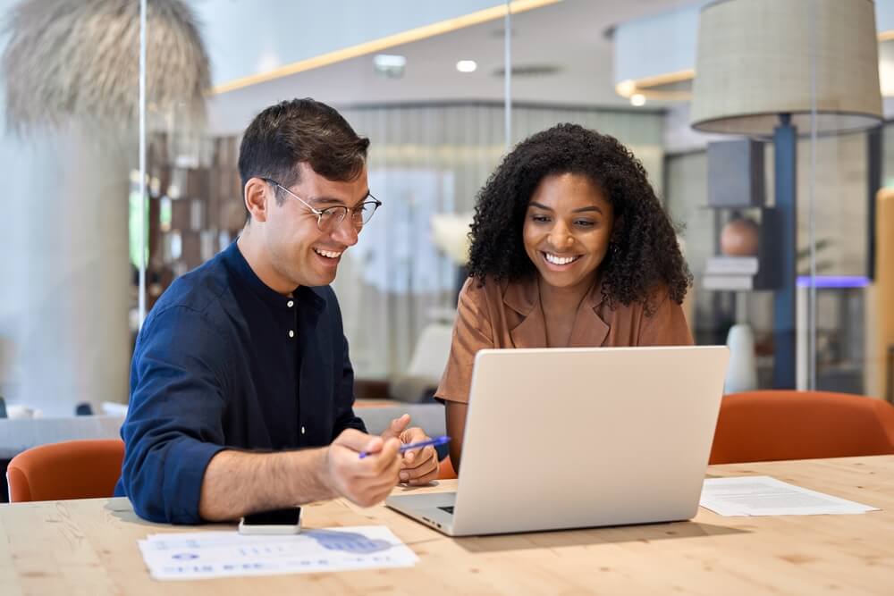 a man and woman taking training through laptop